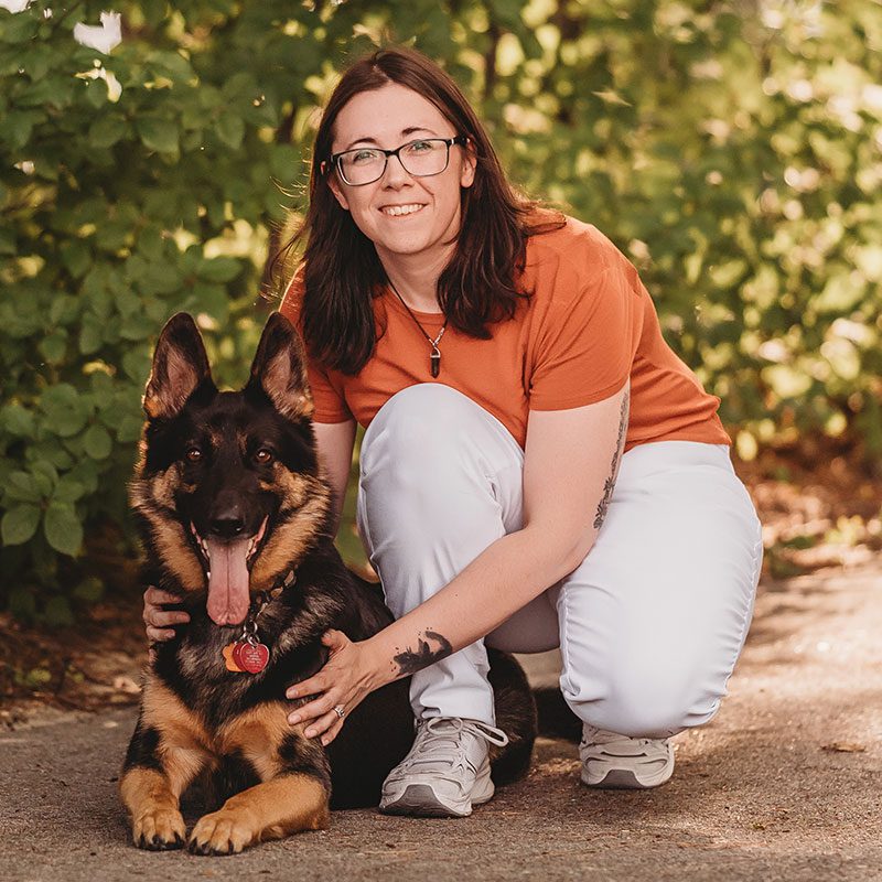 Jenna with her german shepherd on a trail