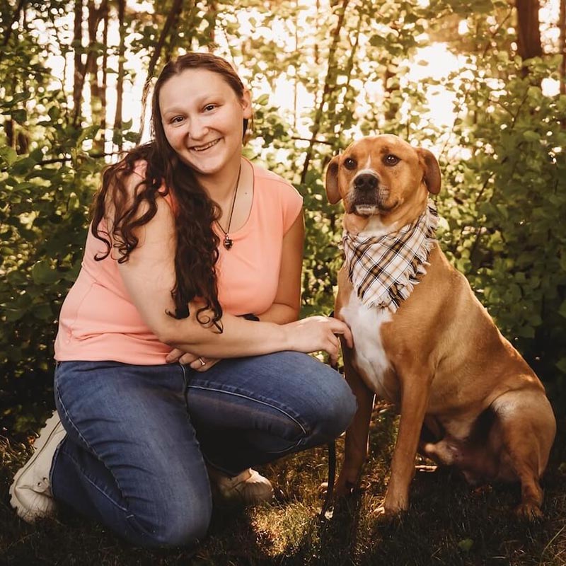 Patty with her dog in the woods
