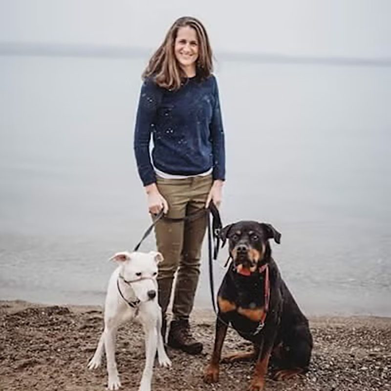 Dr. Karen with her two dogs on the beach