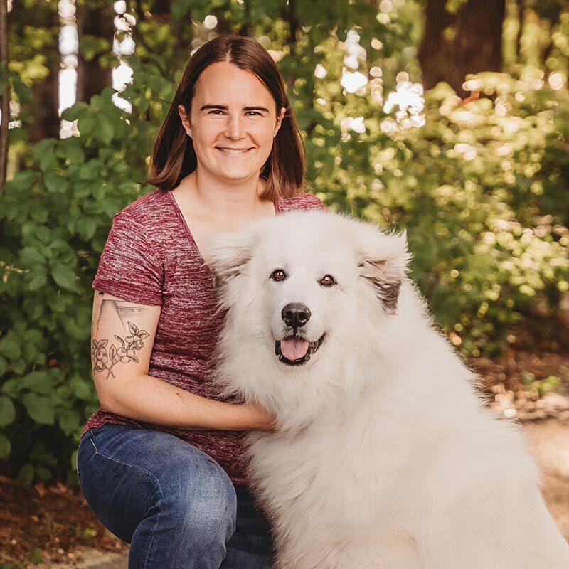 Dr Caitlin Mcnichols with her large fluffy white dog