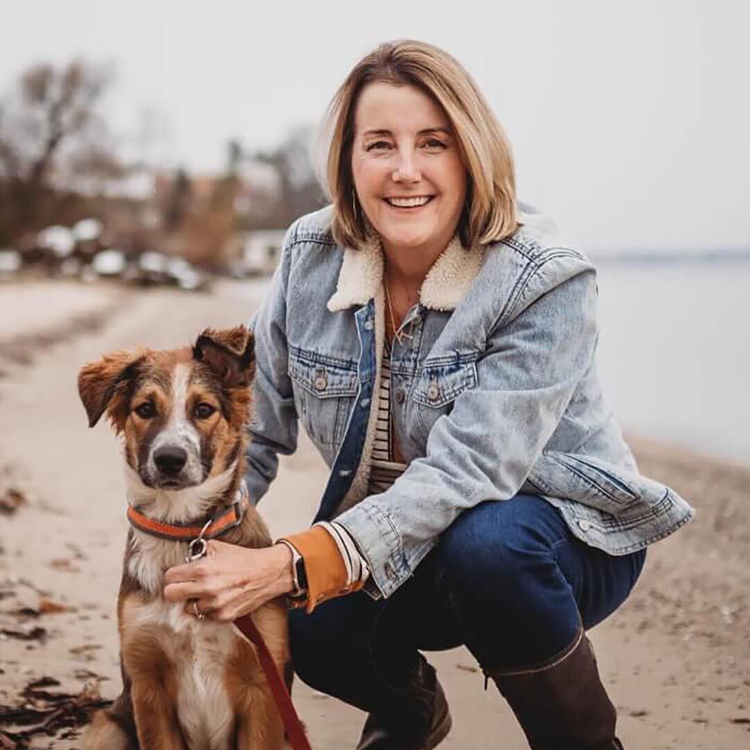 Dr. Kim on the beach with her dog