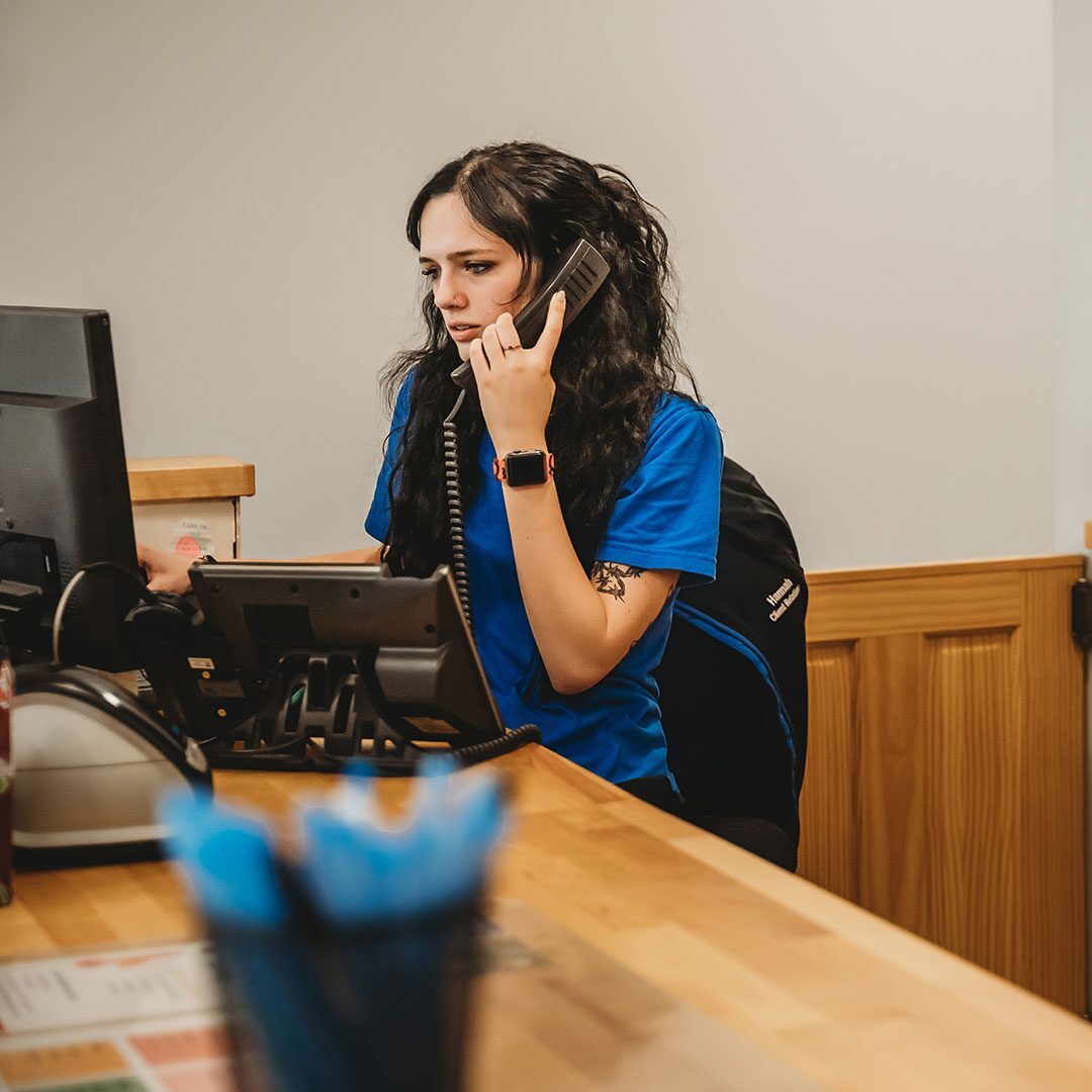 receptionist on the phone with a client